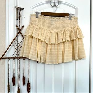 Cream colored mini skirt.